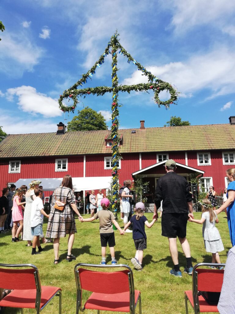 Midsommarfeier mit geschmückter Stange